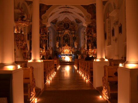 A beautiful church with soft lighting and an impressive altar arrangement. The space radiates a calm and reflective atmosphere.
