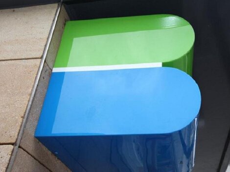 A modern, colorful logo in blue and green. It has rounded corners and is mounted on a wall.