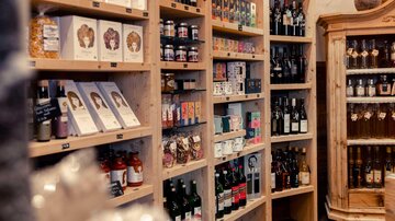 A cozy shop with shelves full of food and drinks. The products are presented in appealing packaging.