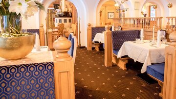 An inviting restaurant with cozy seating areas and elegant decor. The atmosphere is friendly and warm.