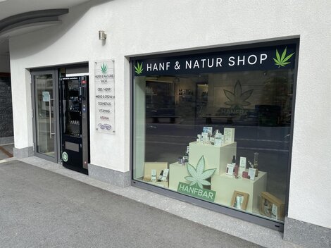 A shop with the sign "Hemp & Nature Shop". Various hemp products are displayed in the window.