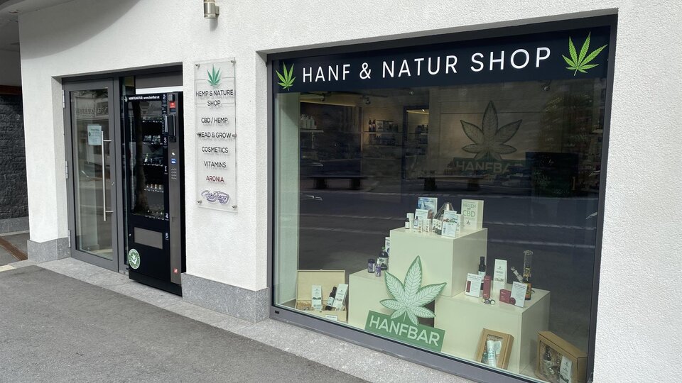 A shop with the sign "Hemp & Nature Shop". Various hemp products are displayed in the window.