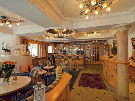 An elegant café with cozy seating and stylish lighting. The decor is warm and inviting, perfect for relaxation and socializing.
