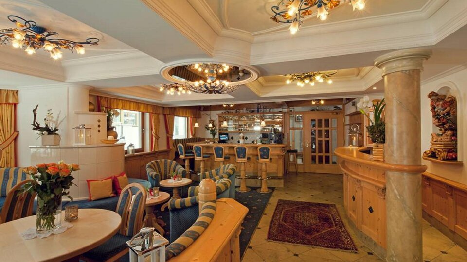 An elegant café with cozy seating and stylish lighting. The decor is warm and inviting, perfect for relaxation and socializing.
