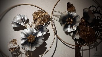 Decorative flower arrangements in modern metal rings. The flowers are available in various colors and add an elegant touch to the room.