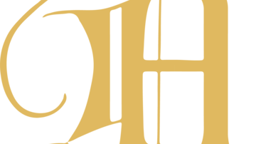 An artistic gold-colored monogram featuring the letter "A". The design is elegant and curved.