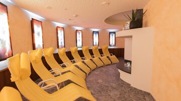 A relaxing lounge with yellow loungers and soft lighting. The walls are painted in warm colors, creating a calming atmosphere.