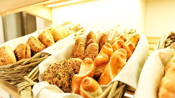 Fresh rolls and pastries in several baskets. The baked goods are tasty and inviting.